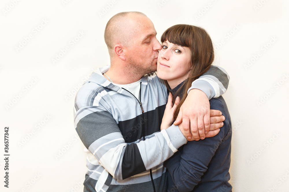 Loving couple kissing and embracing together Loving couple kissing and embracing together