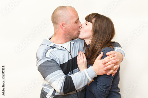 Man and woman a loving couple together kissing