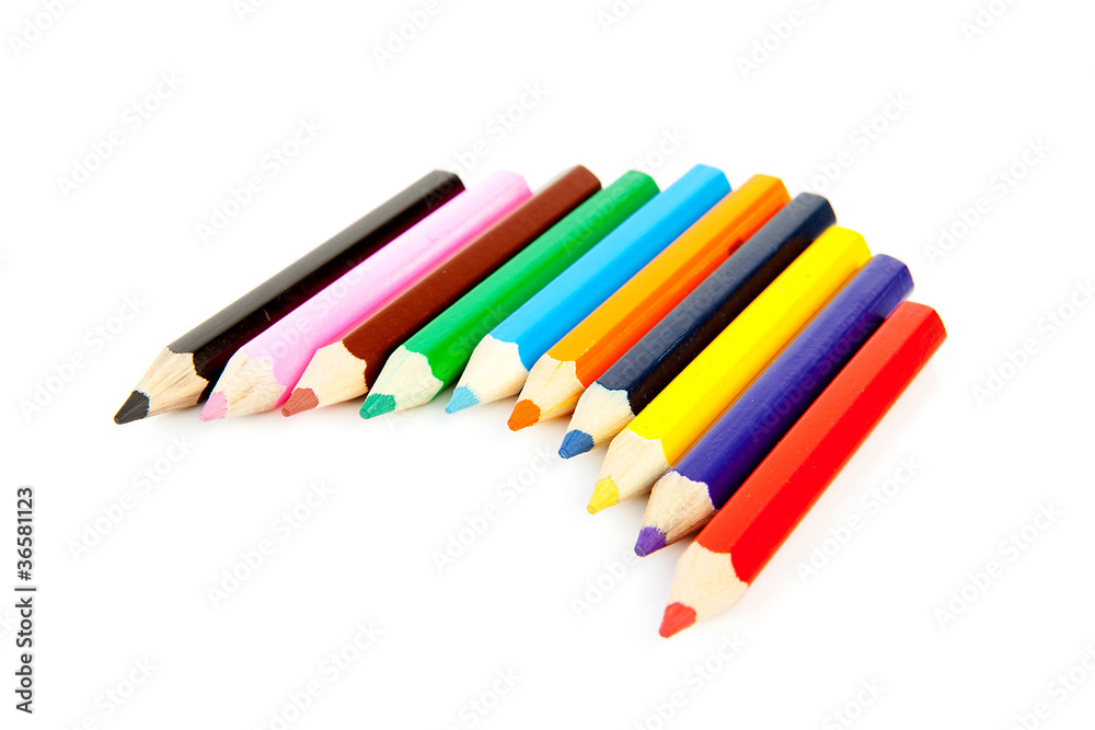 colorful pencils in a row over white background