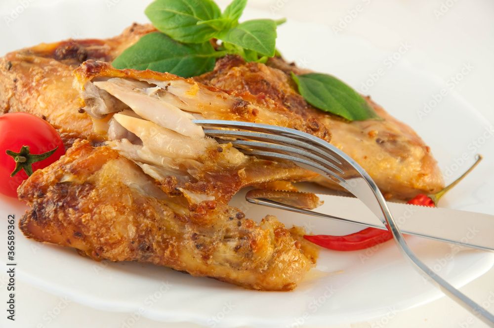 Chicken wings a grill with a tomato and a basil. Chicken wings a grill with a tomato and a basil.