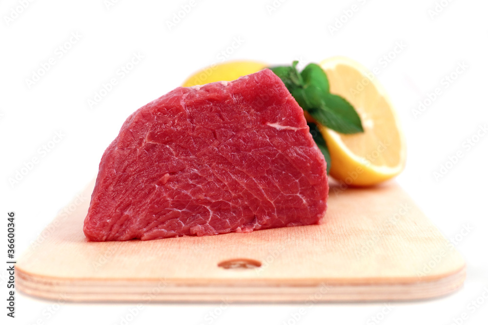 Beef steak on meat hardboard with green leaf and lemon. Beef steak on meat hardboard with green leaf and lemon.
