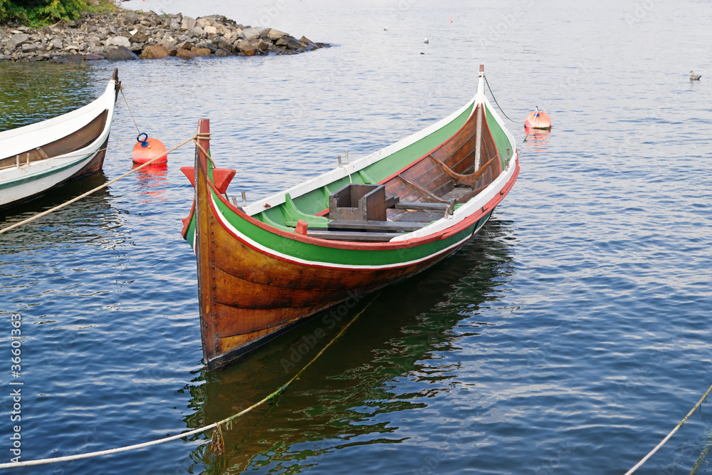 The wooden rowing and sailing boat