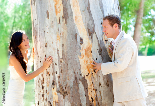 Couple happy in love playing in a tree trunk