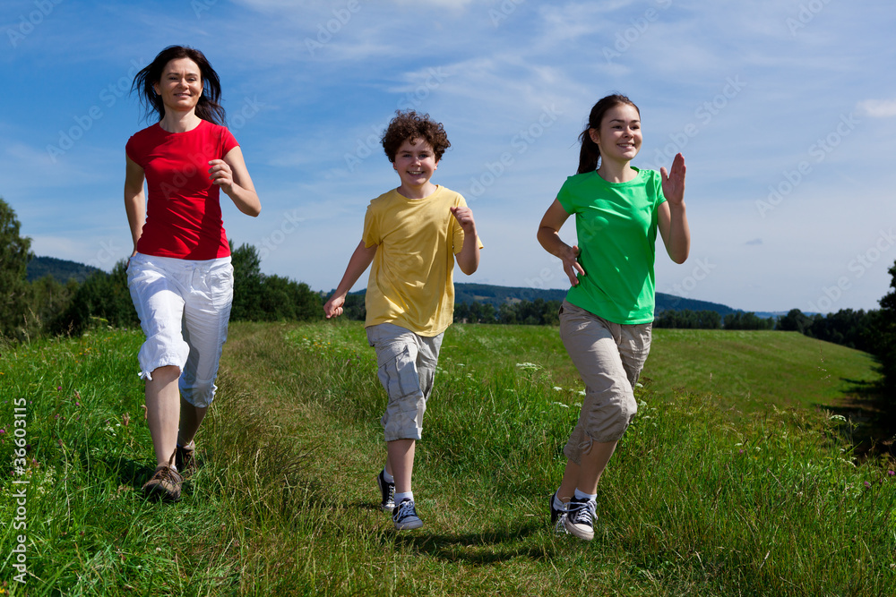 Active family - mother and kids running outdoor Active family - mother and kids running outdoor
