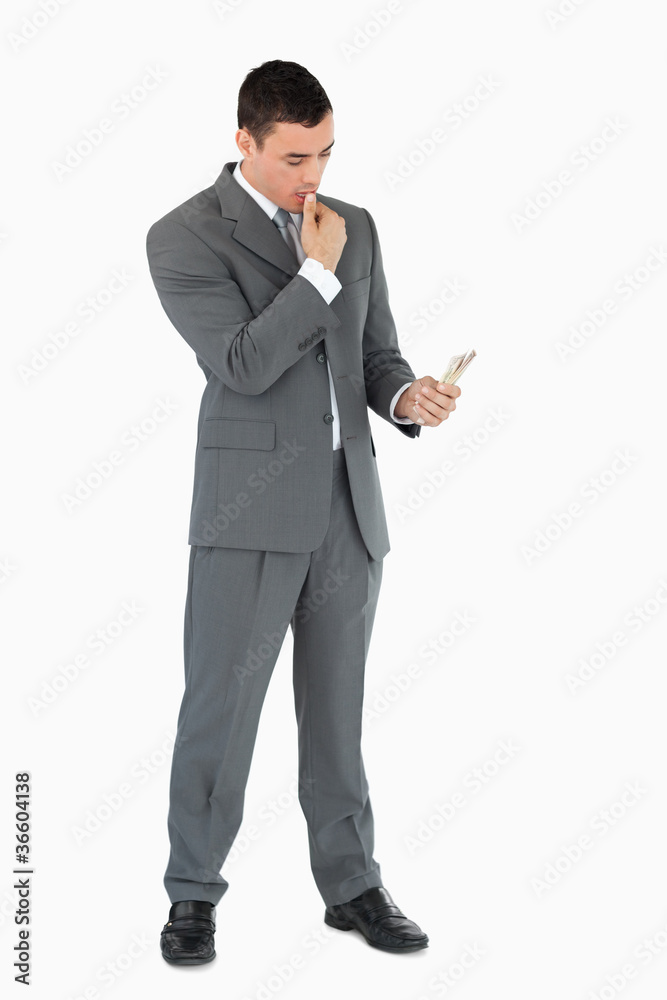 Businessman taking a close look at banknotes Businessman taking a close look at banknotes