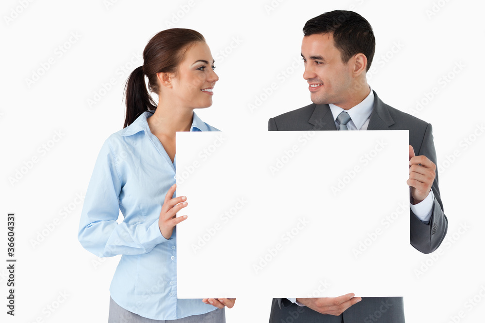 Young business partners presenting sign Young business partners presenting sign