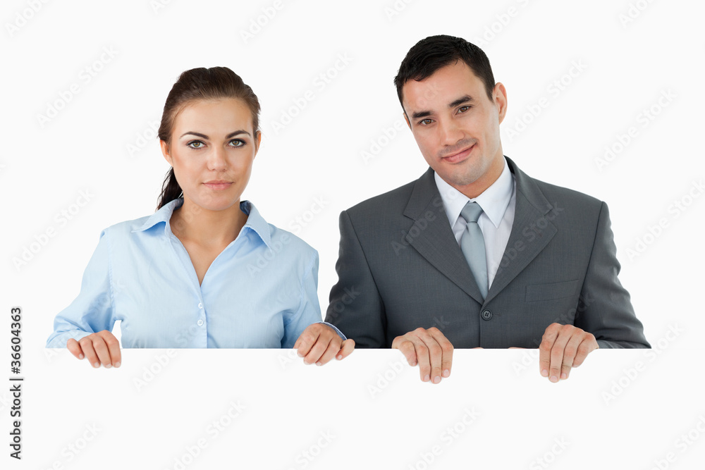 Business partners holding sign Business partners holding sign