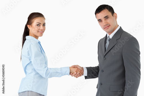 Young business partners shaking hands