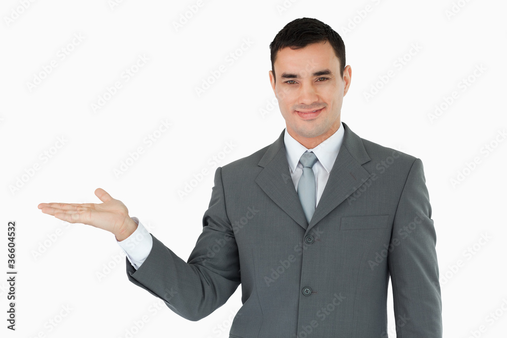 Businessman presenting something in his palm Businessman presenting something in his palm