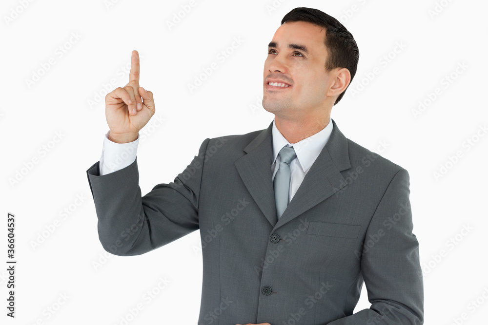 Businessman looking and pointing upwards Businessman looking and pointing upwards