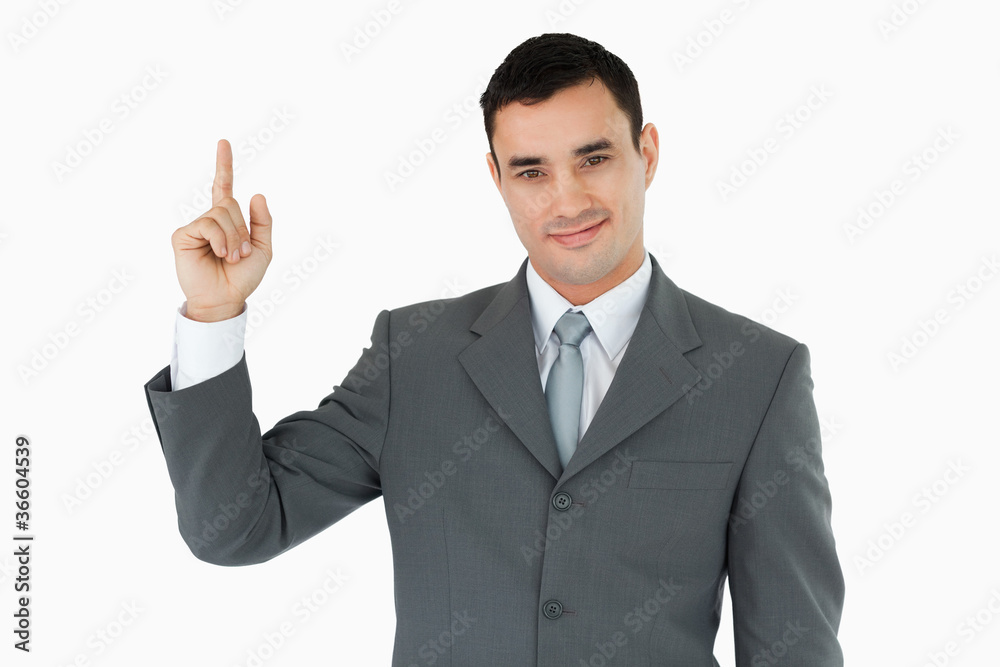 Standing businessman pointing upwads Standing businessman pointing upwads