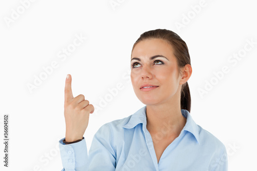 Businesswoman pointing with her finger upwards