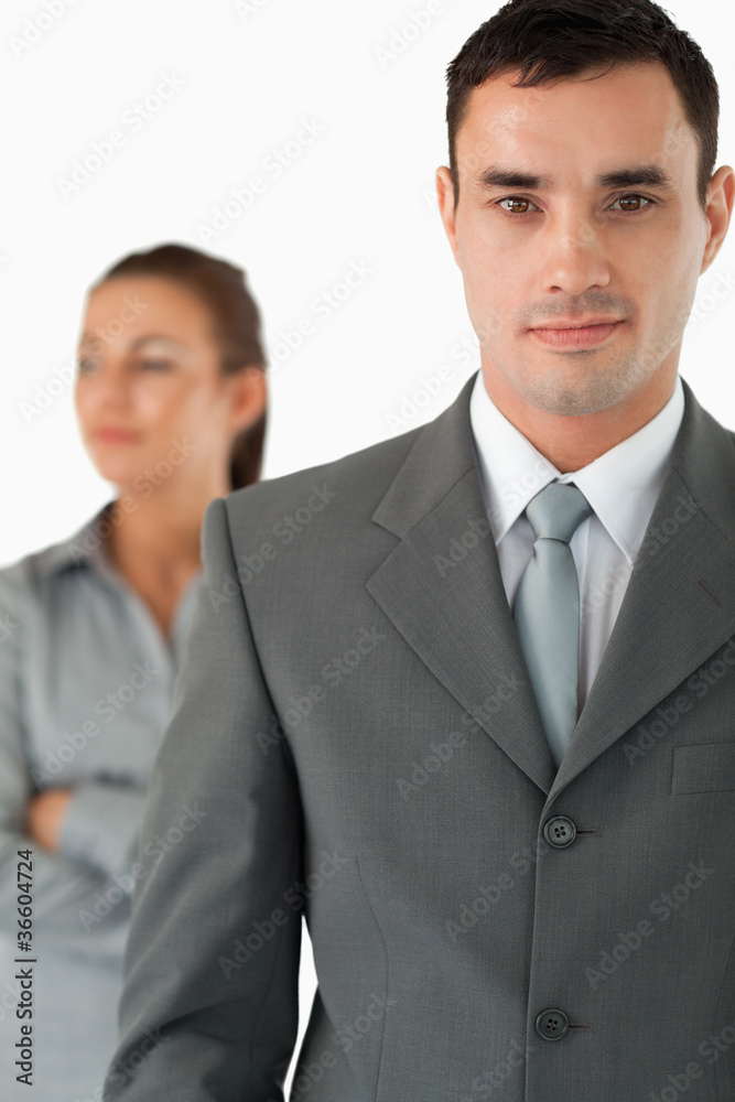 Close up of businessman with colleague behind him Close up of businessman with colleague behind him