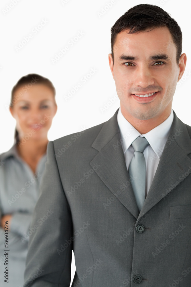 Close up of smiling businessman with colleague behind him Close up of smiling businessman with colleague behind him