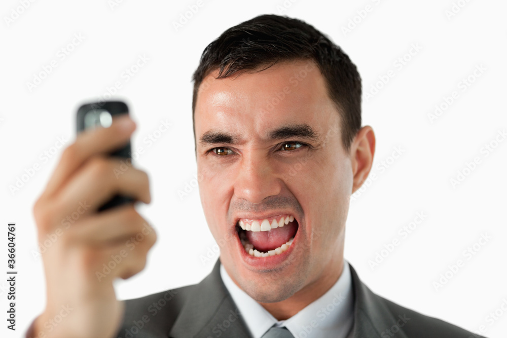 Close up of businessman upset about text message Close up of businessman upset about text message