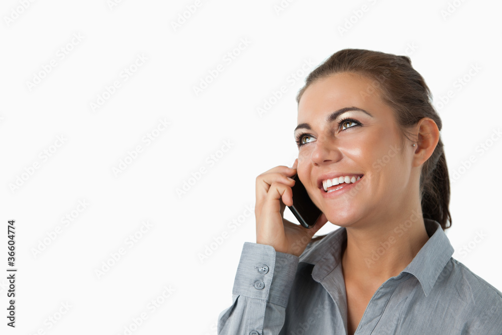 Close up of businesswoman on the phone looking diagonally upward Close up of businesswoman on the phone looking diagonally upward