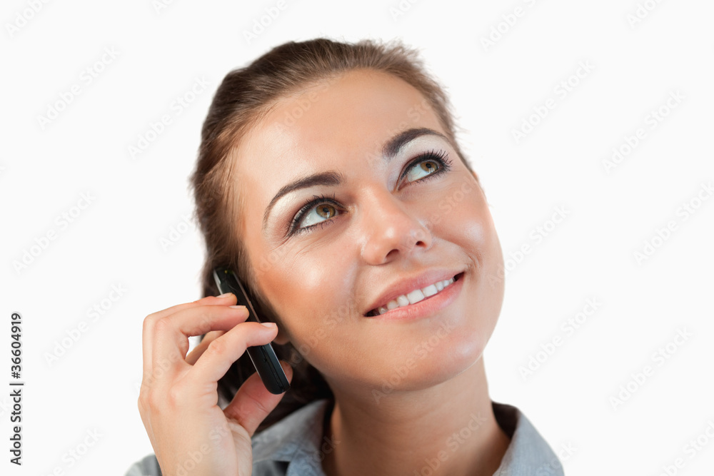 Close up of businesswoman on her phone looking diagonally upward Close up of businesswoman on her phone looking diagonally upward