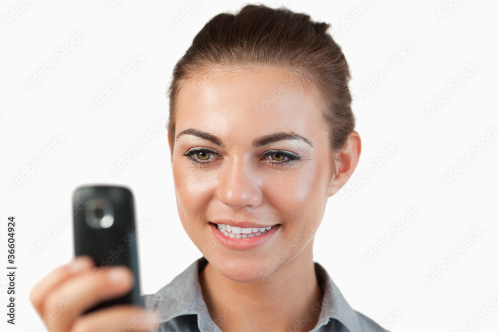 Close up of smiling businesswoman reading a text message Close up of smiling businesswoman reading a text message