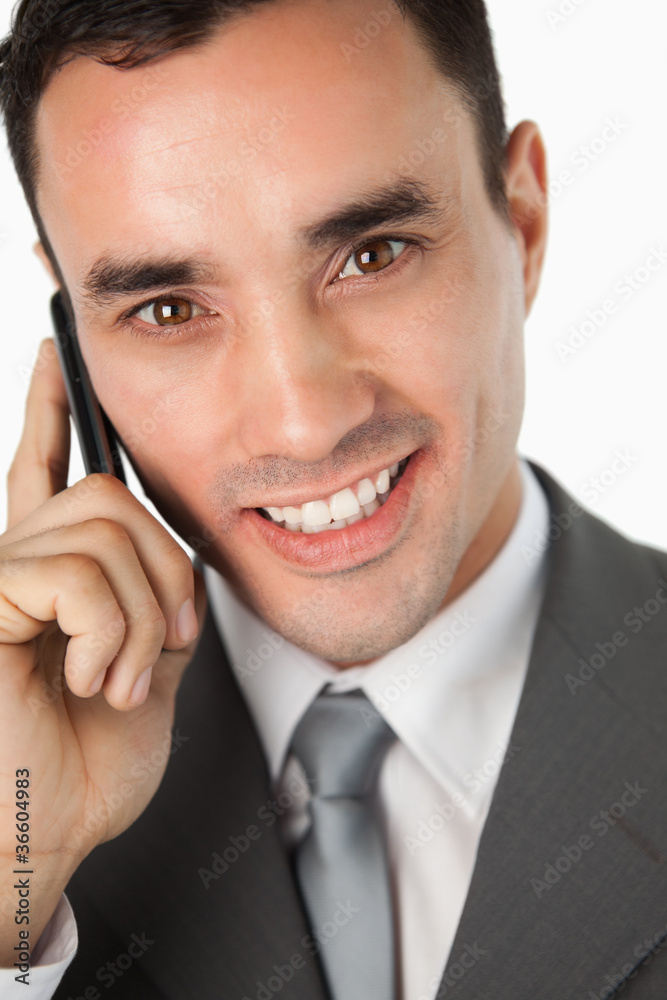 Close up of smiling young businessman on the phone Close up of smiling young businessman on the phone