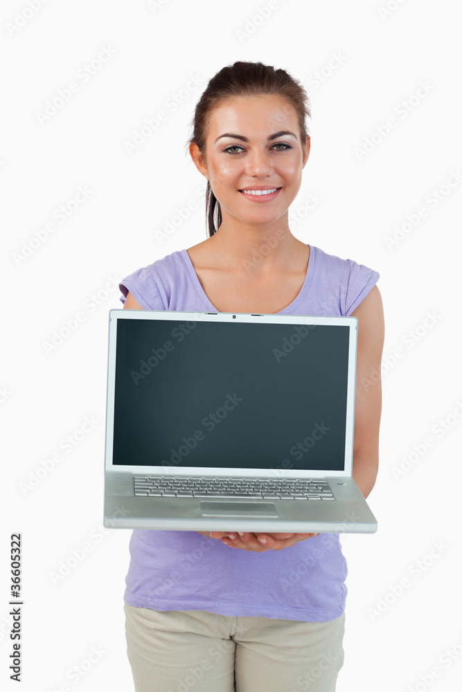 Smiling young female showing her laptop Smiling young female showing her laptop