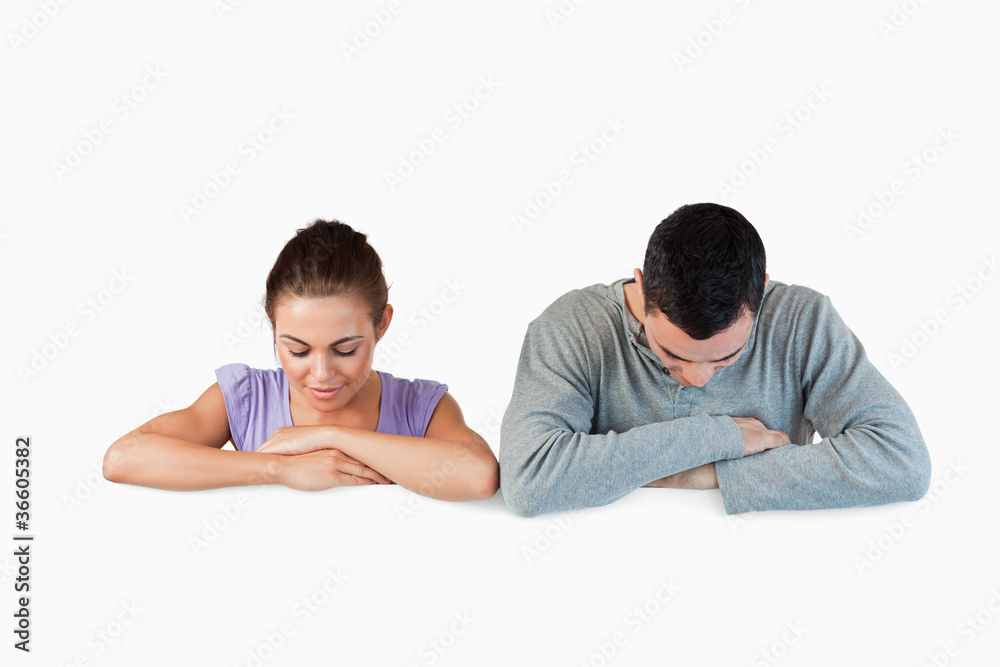 Young couple looking down to an advertisement Young couple looking down to an advertisement