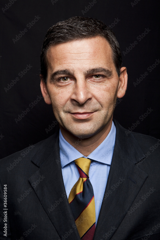 Portrait of confident businessman over black background Portrait of confident businessman over black background