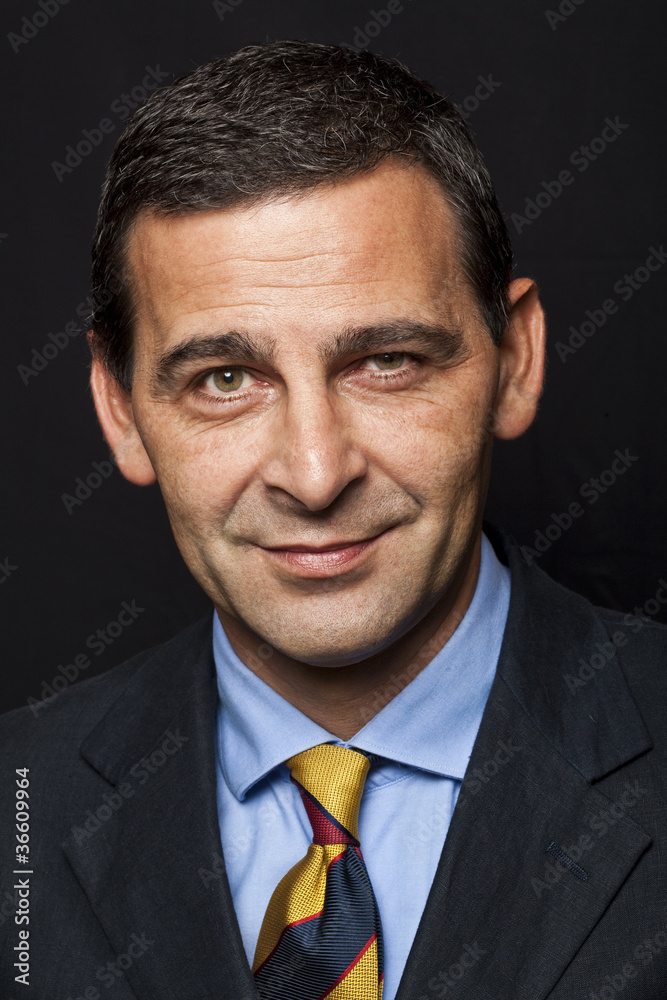 Portrait of confident businessman over black background Portrait of confident businessman over black background