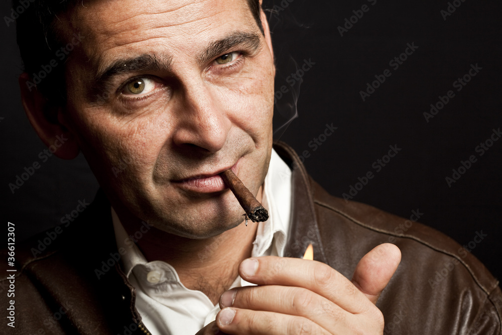 portrait of a cool mature man smoking a cigar portrait of a cool mature man smoking a cigar