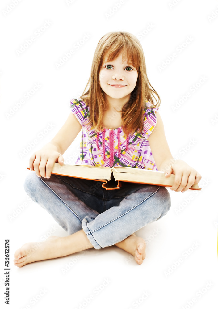 A little girl reading a book on the floor A little girl reading a book on the floor