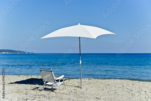 Chair and beach umbrella © AlexanderNikiforov
