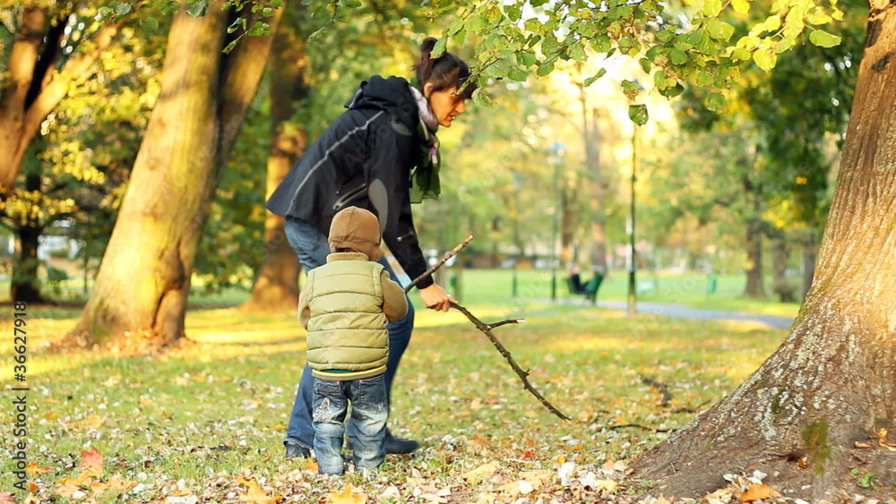 Young mother having fun with her son in beautiful autumn park Young mother having fun with her son in beautiful autumn park