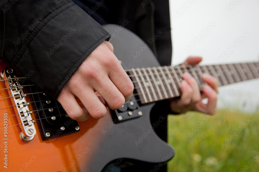 Fototapeta premium Close up of a man playing guitar