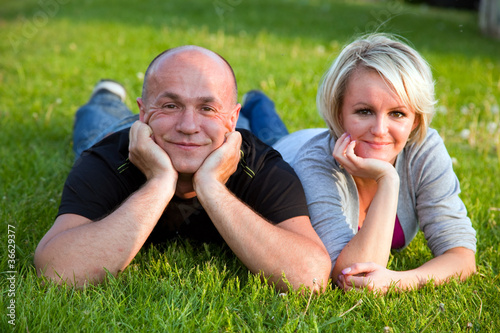 Adult happy couple together on grass