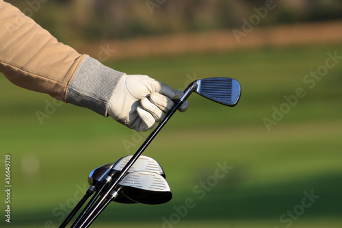 Golfer removing his driver from a golf bag