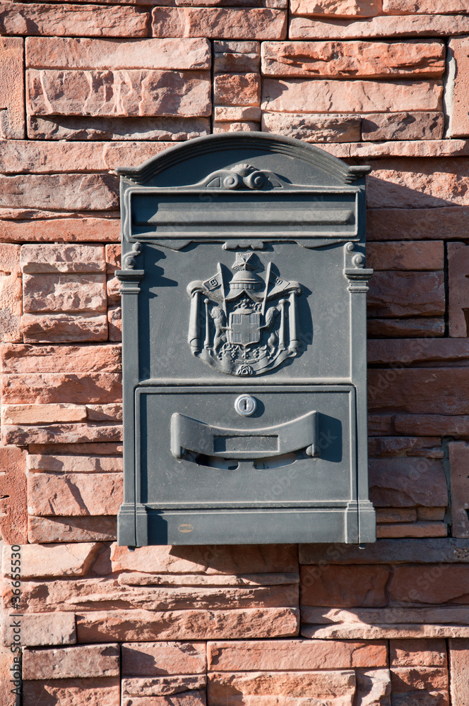 Beautiful mailbox on a brick wall, a summer day