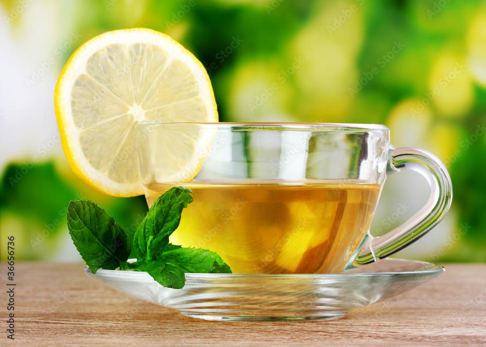 tea with lemon on green leaves background tea with lemon on green leaves background