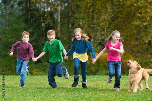 Group of kids running in a field