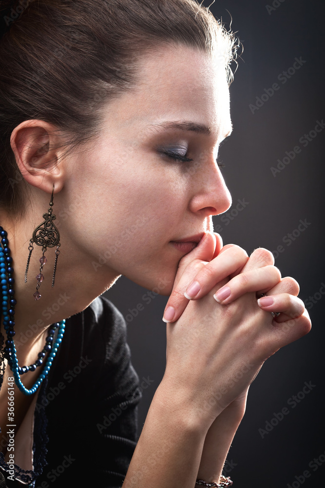 Religion concept - woman and her prayer