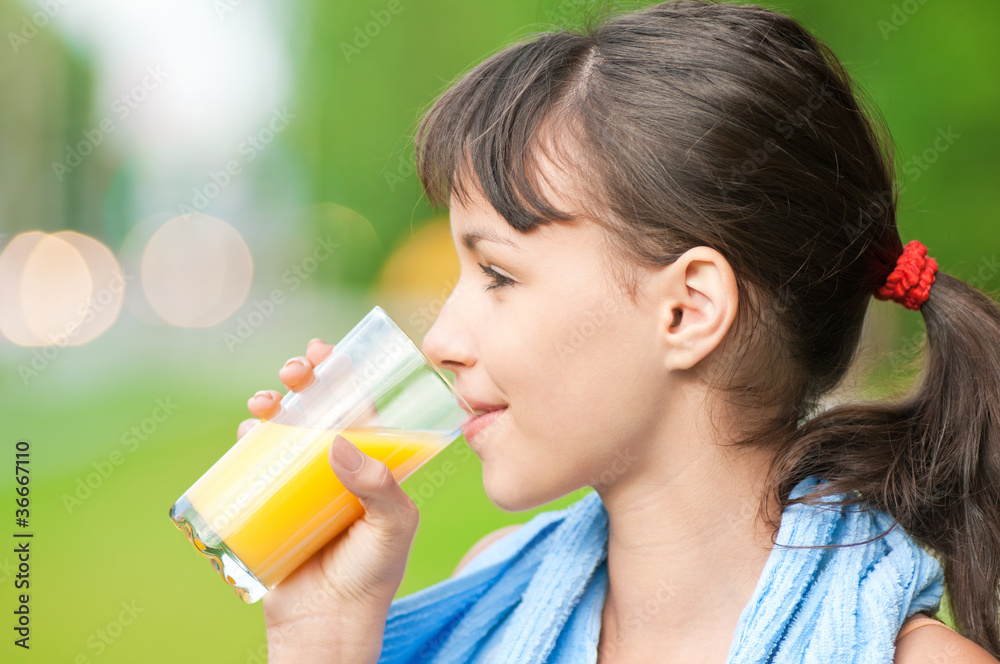 Girl drinking juice after exercise Girl drinking juice after exercise