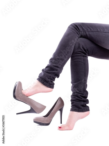 The woman sit and took off her shoes isolated