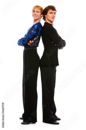 Two ballroom male dancers standing back to back