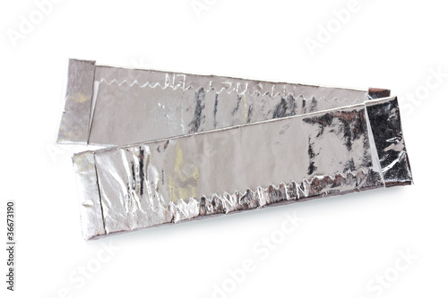 Obraz na plátně two chewing gums wrapped in standard silver foil, isolated
