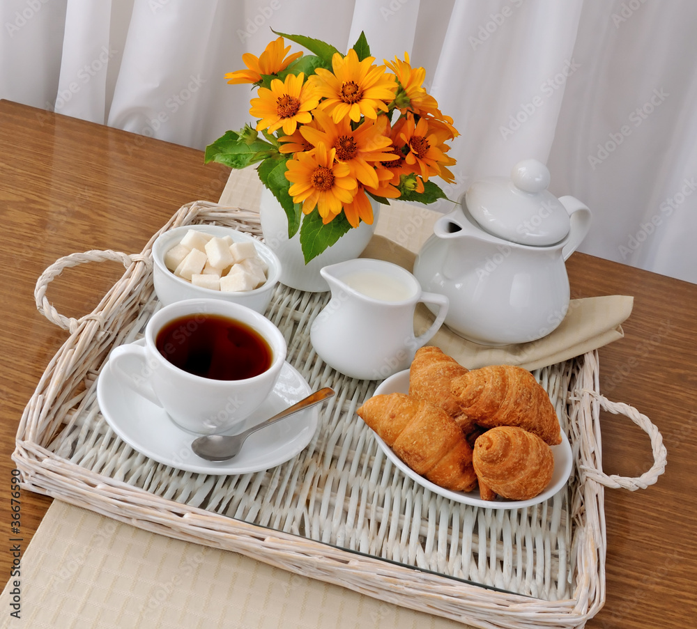 croissants with tea and milk on a tray croissants with tea and milk on a tray
