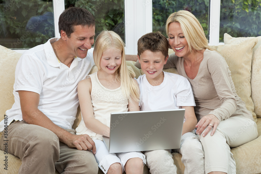 Happy Family Having Fun Using A Computer At Home Happy Family Having Fun Using A Computer At Home