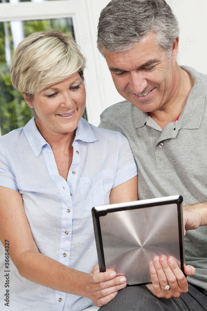 Happy Man & Woman Couple Using Tablet Computer Happy Man & Woman Couple Using Tablet Computer
