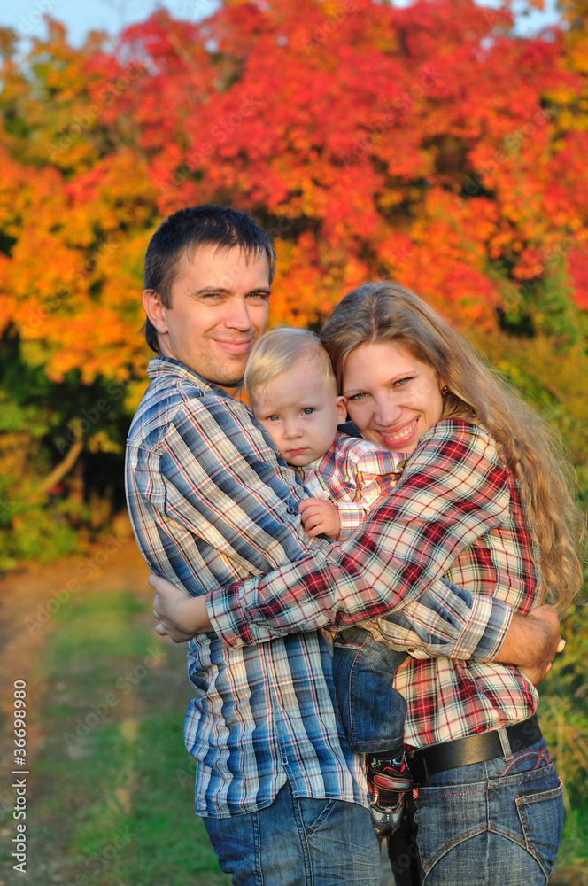 Fototapeta premium Young family in autumn forest