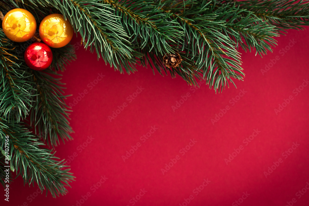 christmas card with baubles and fir tree  on red
