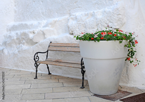 Giant white flowerpot with red geraniums, Italy