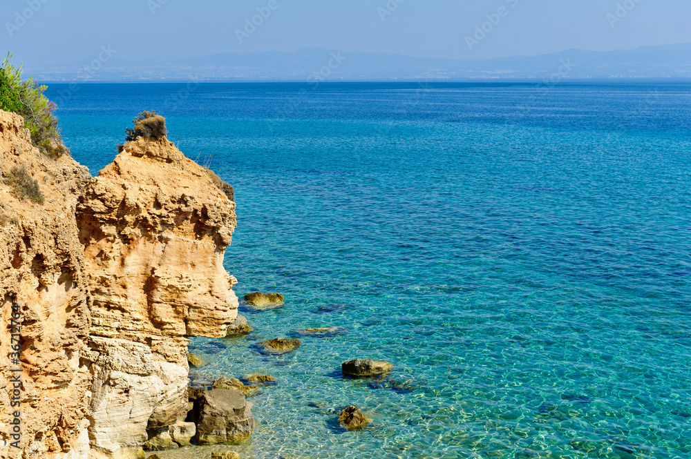 Transparent turquoise sea, sand rock