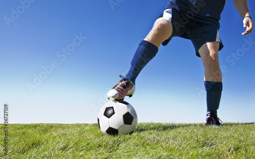 Soccer player kicking the ball during a game © Brocreative